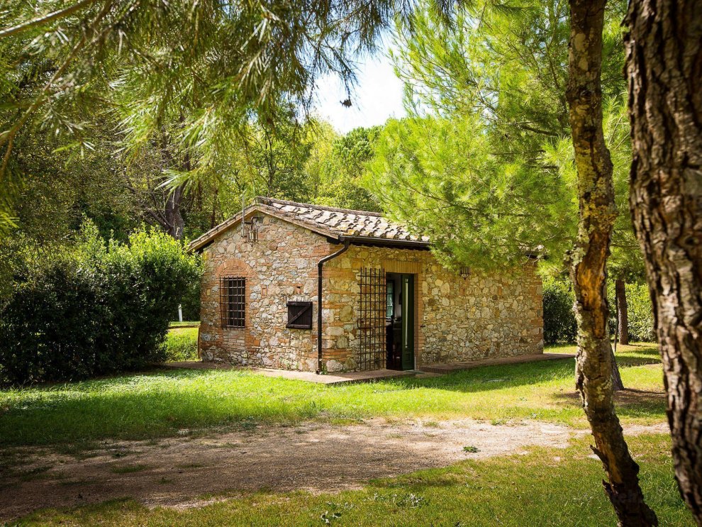 A rustic house set in the Tuscan landscape.